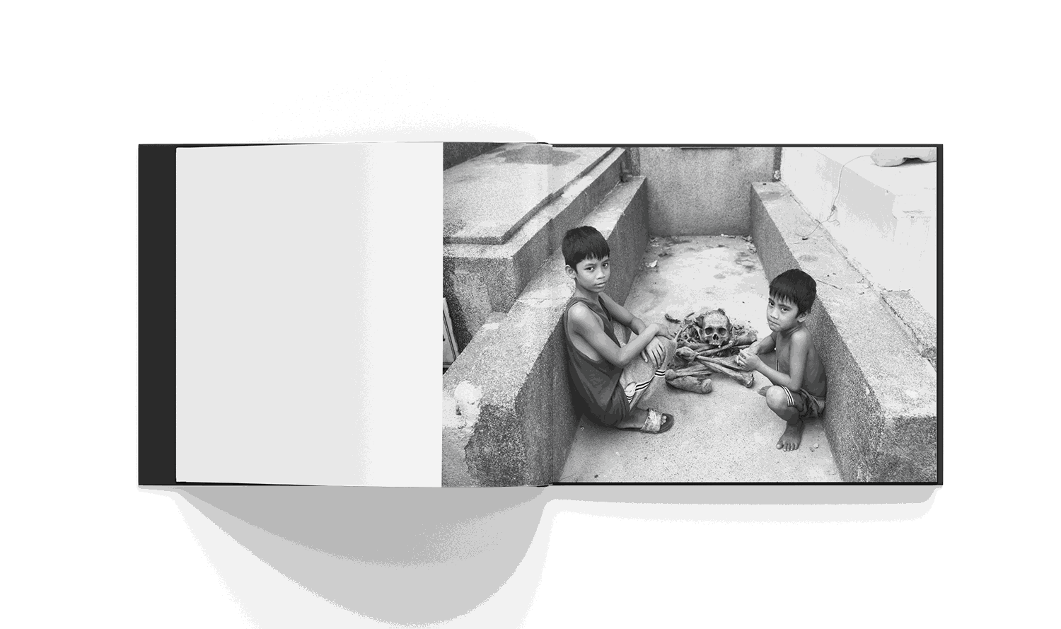 Cemetery City book by Brad Mirman featuring children and human skeleton in Manila cemetery black and white photo