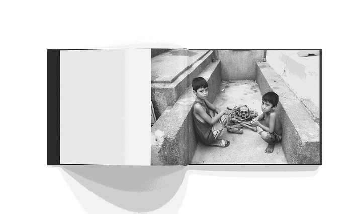 Cemetery City book by Brad Mirman featuring children and human skeleton in Manila cemetery black and white photo