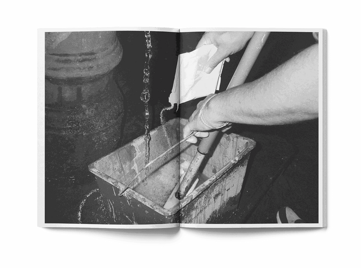 Open book showing street art mural with skull and Colosseum, man in red shirt painting wall, Lucamaleonte Colla 00139 book photo