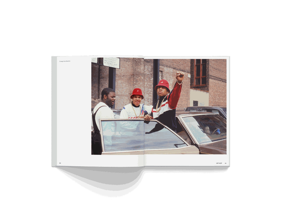 Open book showing a colorful street photo of three men by a car, from Janette Beckman's "Rebels, From Punk to Dior" photography monograph