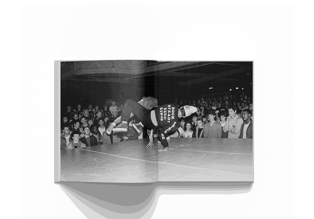 Janette Beckman photography book featuring black and white image of a breakdancer performing in front of a crowd