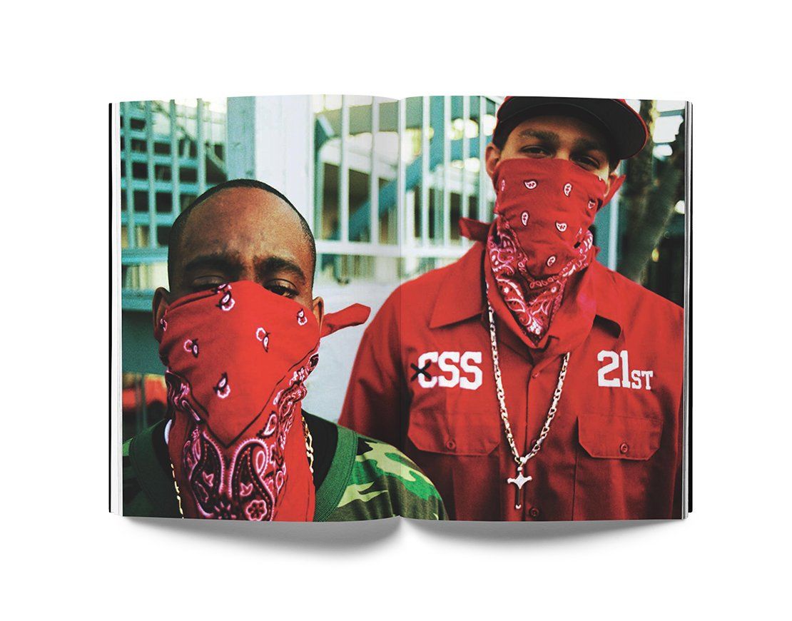 Open book showing portraits of two men with red bandanas covering their faces, one wearing camouflage and the other a red shirt with chain necklace, from Estevan Oriol's LA Portraits photo collection.