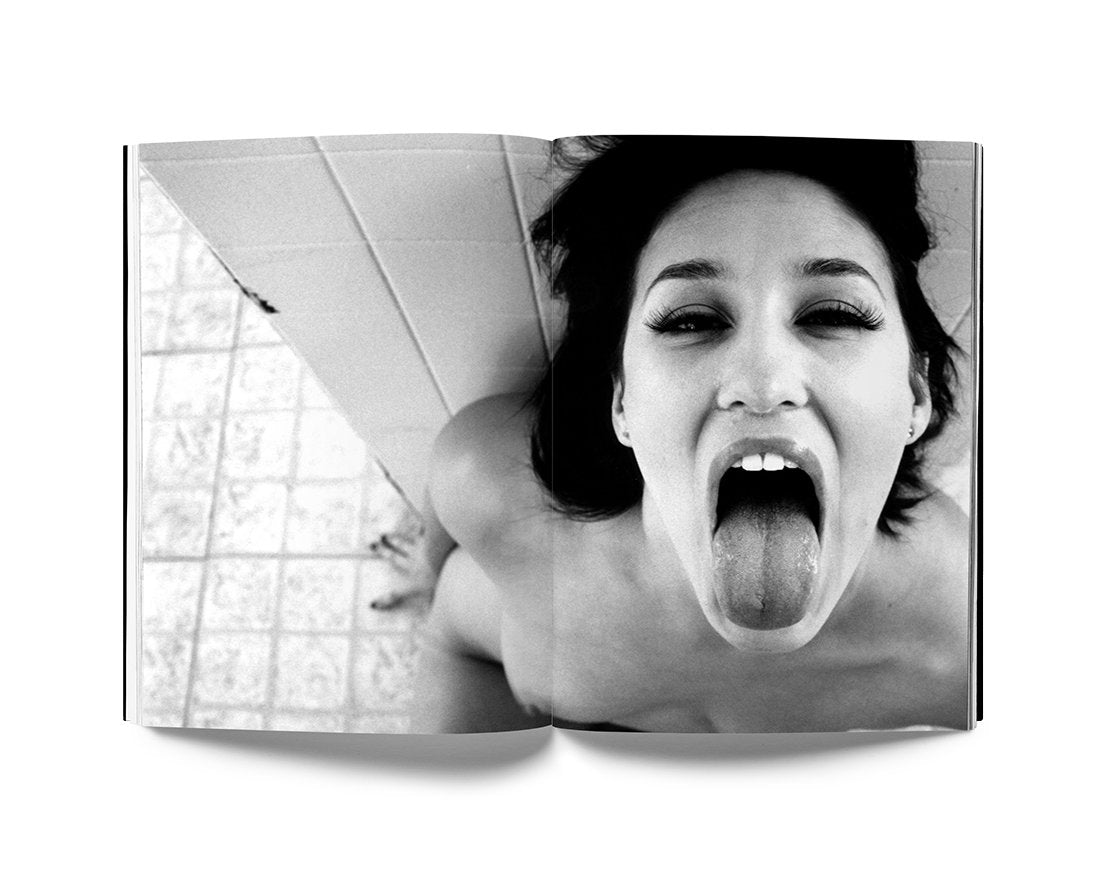Black and white photo of a woman sticking out her tongue, from Estevan Oriol's LA Woman photo book showcasing natural feminine beauty