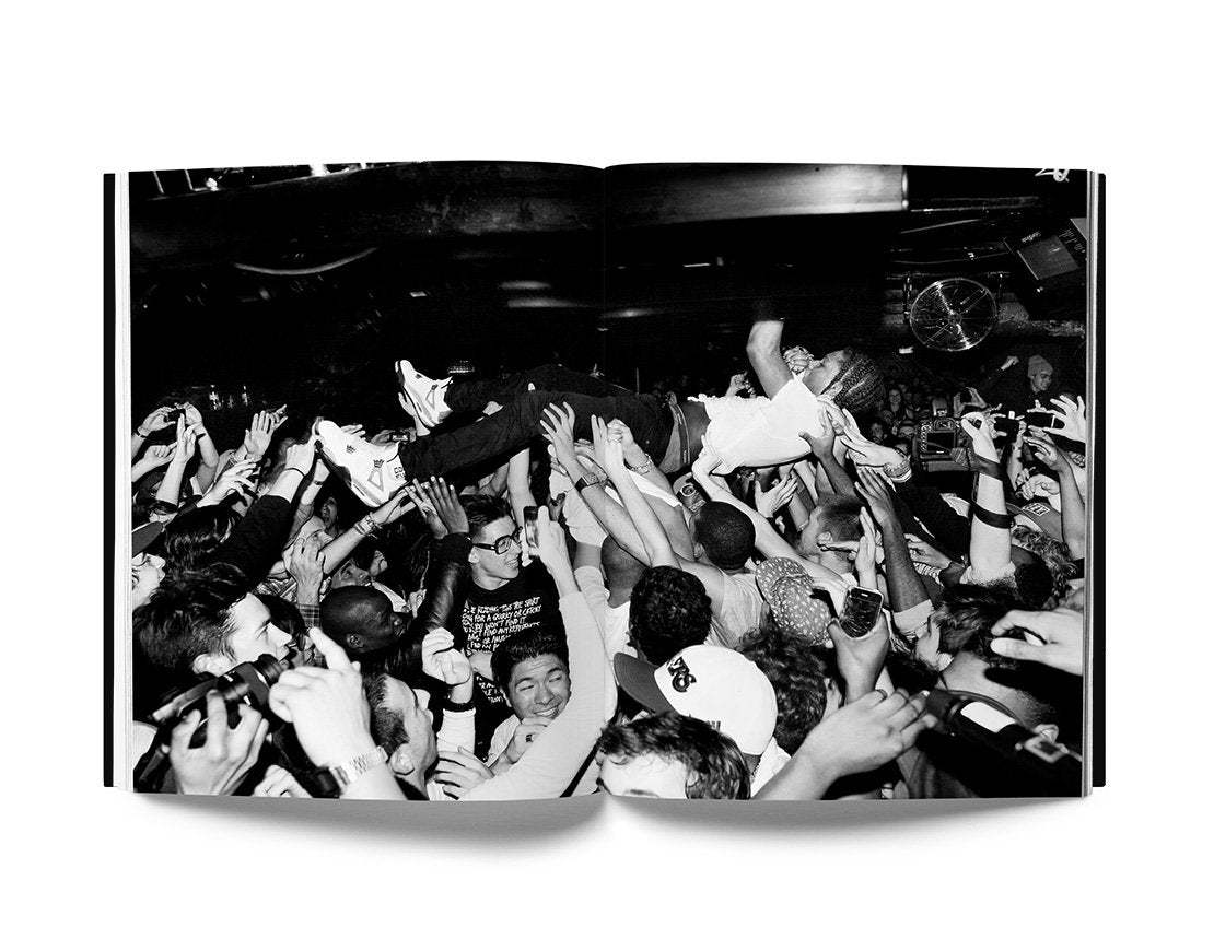 Keffer The Night Day book open to black and white photo of a crowded concert with a person crowd surfing