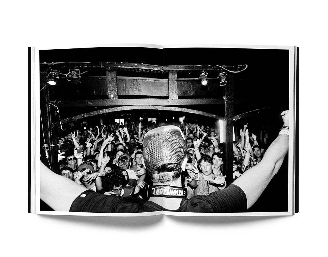 Keffer The Night Day book open showing black and white photo of a DJ performing to a lively crowd