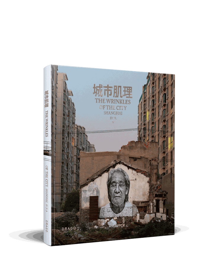 Cover of JR's Wrinkles Of The City Shanghai featuring elderly portrait mural on urban wall