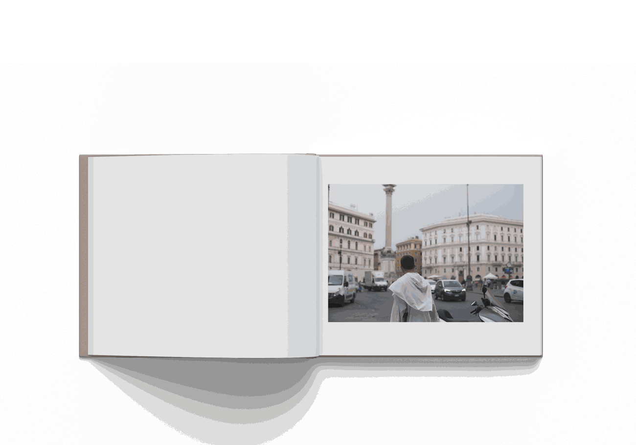 Open photo book "Mohamed Keita Rome 10/20" showing a man facing Rome cityscape with historical buildings and traffic.