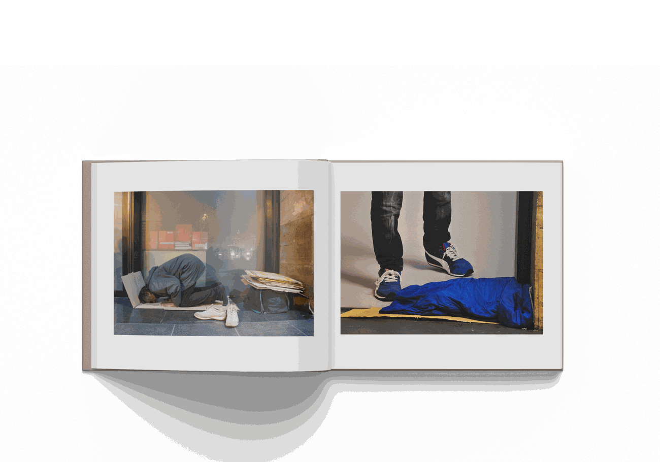Open book showcasing two poignant photographs by Mohamed Keita from Rome 10/20 project, highlighting urban and human elements.