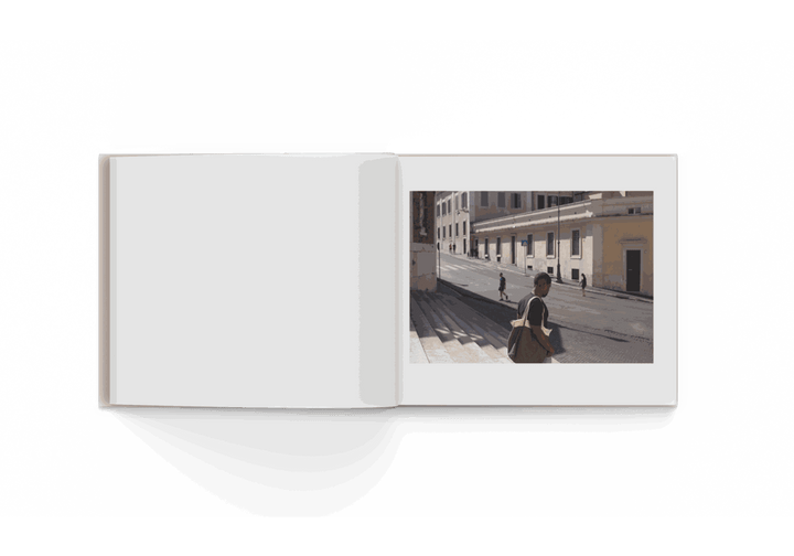 Open photo book "Rome 10/20" by Mohamed Keita featuring street scene with people and buildings in Rome